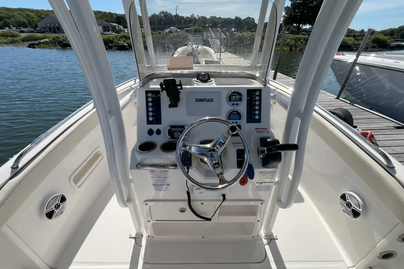 Slide: The Image of 2019 Robalo R222 Explorer boat dashboard with steering wheel and controls. - 3
