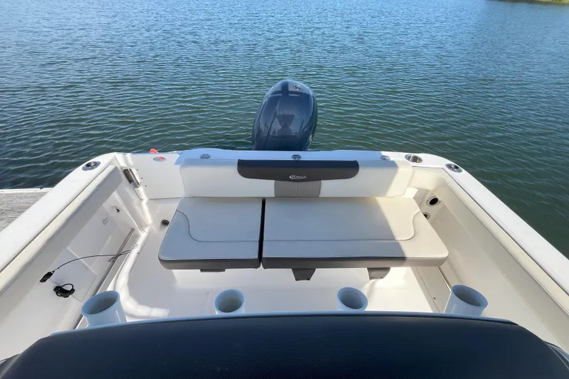 Slide: The Image of 2019 Robalo R222 Explorer boat interior with seating, overlooking calm water. - 4