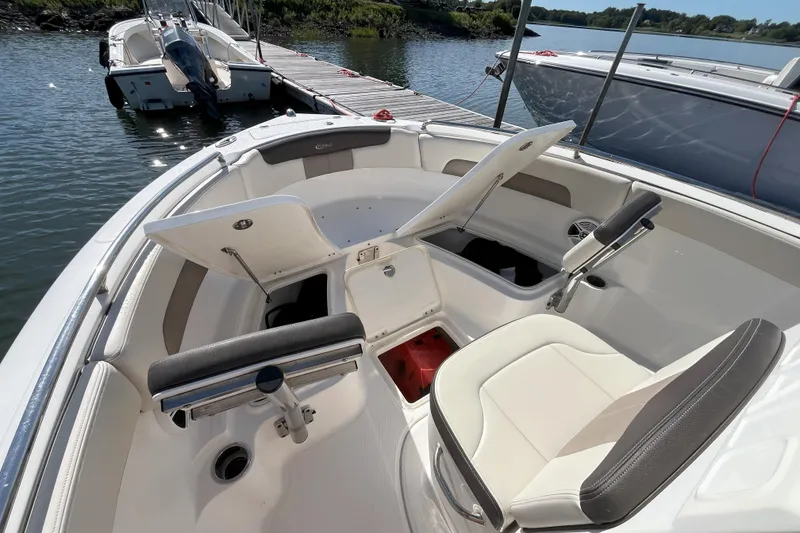 Slide: The Image of 2019 Robalo R222 Explorer boat interior with open storage compartments at dock. - 7