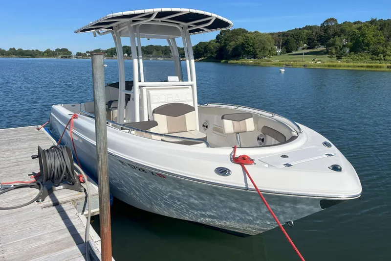 Slide: The Image of 2019 Robalo R222 Explorer boat docked on calm lake with clear blue sky. - 9