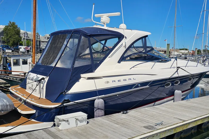 Slide: The Image of 2005 Regal Commodore 4260 yacht docked at marina under clear blue sky. - 1