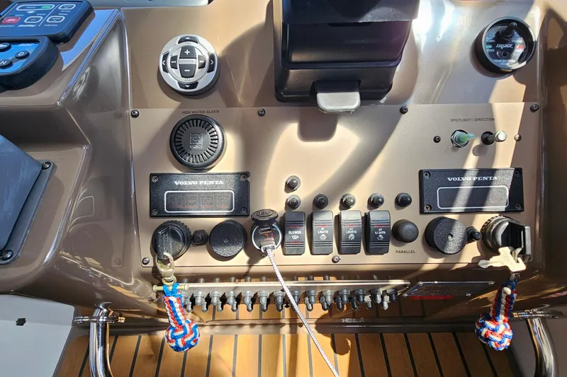 Slide: The Image of Control panel of a 2005 Regal Commodore 4260 boat with various switches and gauges. - 11