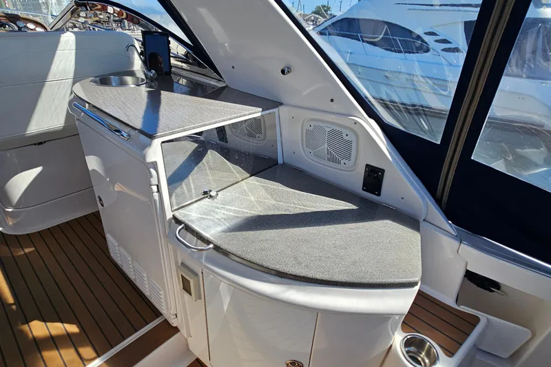 Slide: The Image of 2005 Regal Commodore 4260 yacht interior with sleek kitchenette and modern design. - 13