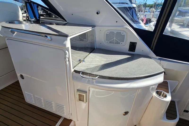 Slide: The Image of 2005 Regal Commodore 4260 yacht interior with sleek countertop and built-in speaker. - 14
