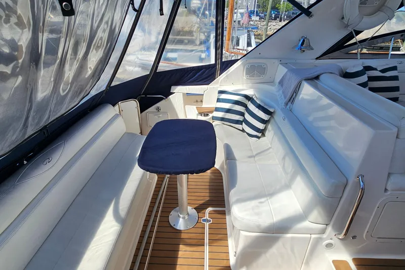 Slide: The Image of Luxurious 2005 Regal Commodore 4260 yacht interior with white seating and striped cushions. - 15