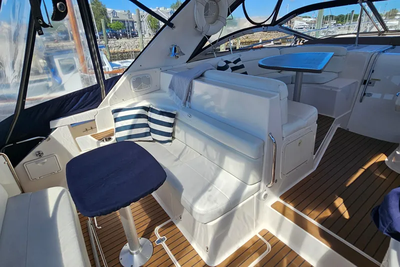 Slide: The Image of Luxurious 2005 Regal Commodore 4260 yacht interior with white seating and striped cushions. - 16