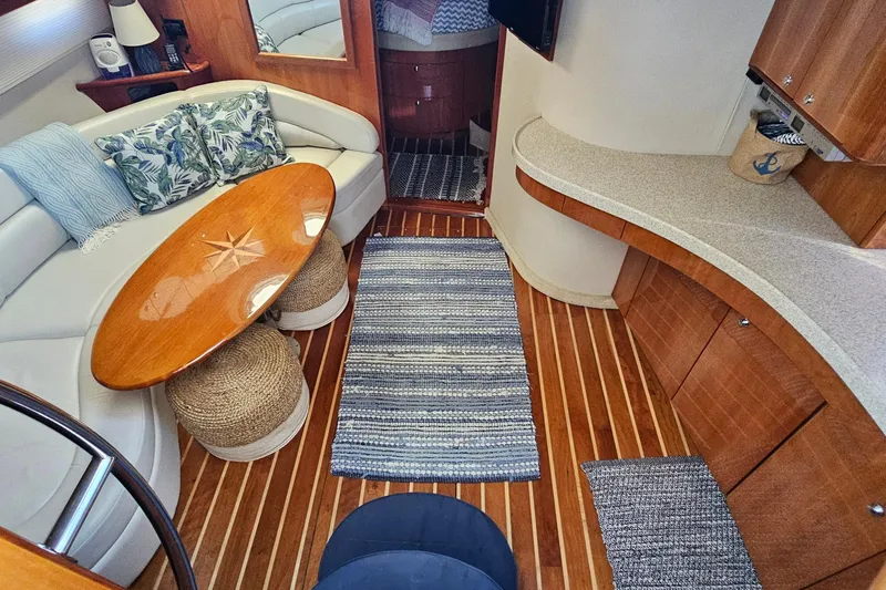 Slide: The Image of Luxurious 2005 Regal Commodore 4260 yacht interior with elegant seating and wooden flooring. - 20