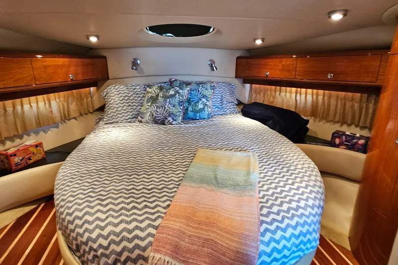 Slide: The Image of Luxurious cabin interior of 2005 Regal Commodore 4260 yacht with cozy bedding. - 24
