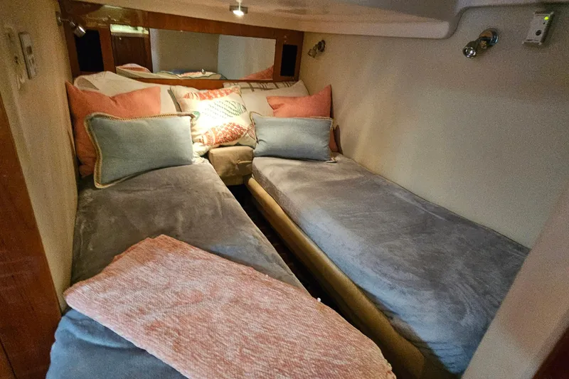 Slide: The Image of Cozy cabin interior of 2005 Regal Commodore 4260 with twin beds and decorative pillows. - 27