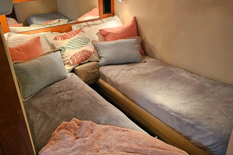 Slide: The Image of Cozy twin beds in 2005 Regal Commodore 4260 cabin with colorful pillows. - 28