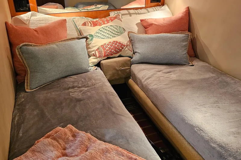 Slide: The Image of Cozy twin beds in 2005 Regal Commodore 4260 cabin with colorful pillows. - 29