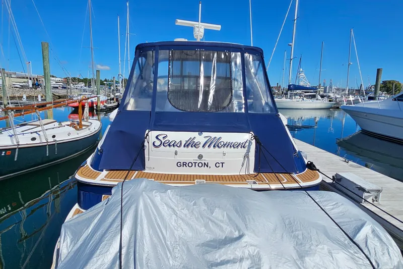 Slide: The Image of 2005 Regal Commodore 4260 yacht docked in Groton, CT marina, named "Seas the Moment". - 3