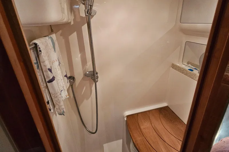 Slide: The Image of Shower area in 2005 Regal Commodore 4260 yacht with wooden seat and towel. - 31
