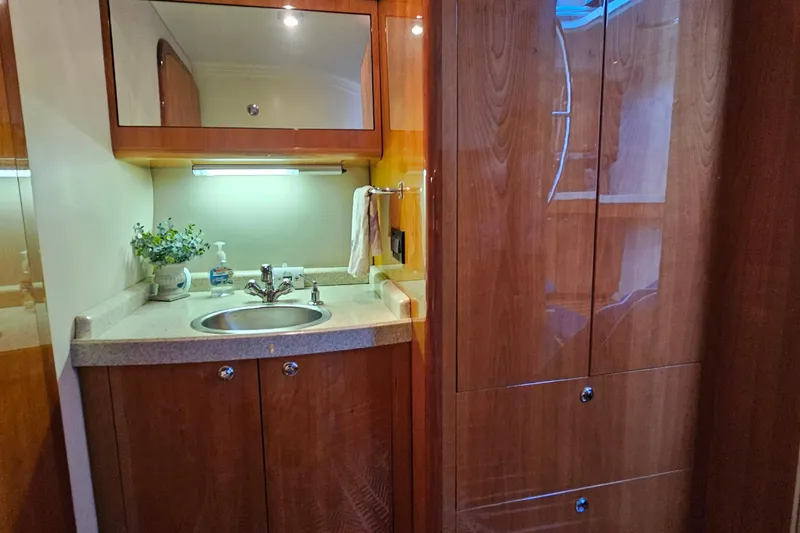 Slide: The Image of Luxurious 2005 Regal Commodore 4260 yacht bathroom with wooden cabinetry and modern sink. - 33