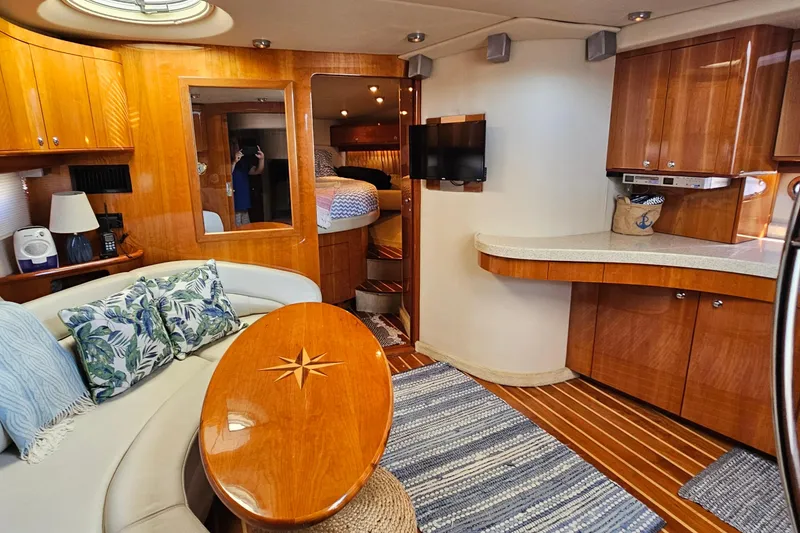 Slide: The Image of Luxurious 2005 Regal Commodore 4260 yacht interior with elegant wood finishes and cozy seating. - 34