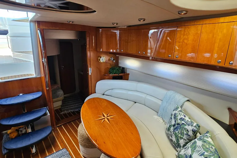 Slide: The Image of Luxurious 2005 Regal Commodore 4260 yacht interior with elegant wood finishes and plush seating. - 35