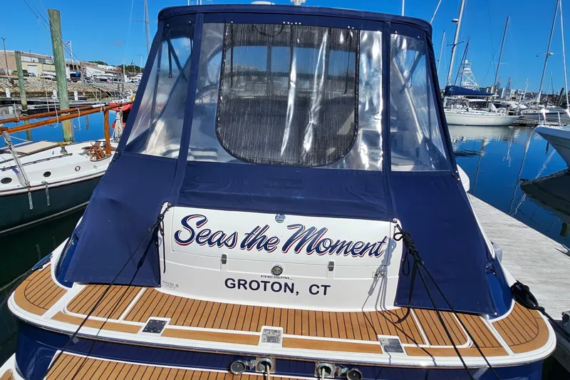 Slide: The Image of 2005 Regal Commodore 4260 yacht named "Seas the Moment" docked in Groton, CT marina. - 4
