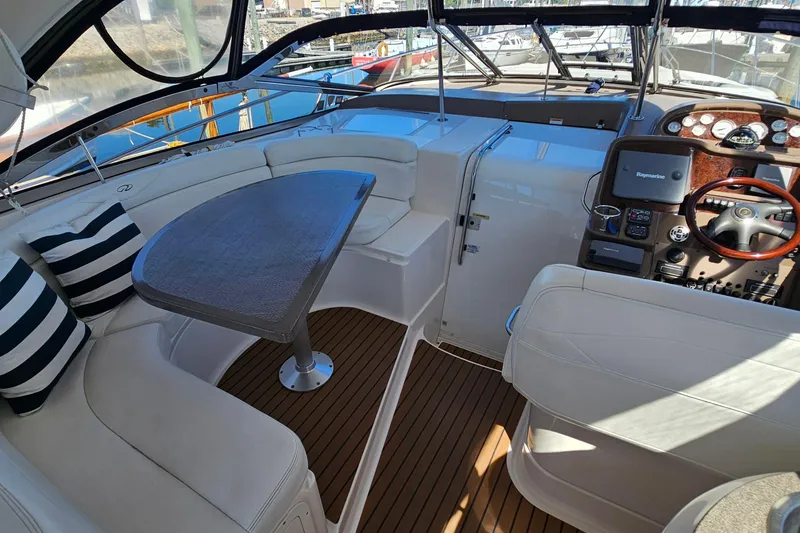 Slide: The Image of Luxurious 2005 Regal Commodore 4260 yacht interior with seating, table, and helm. - 7