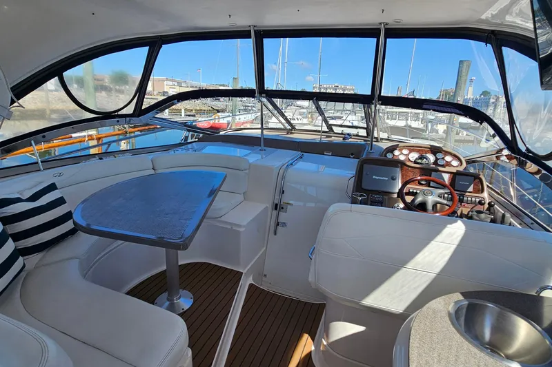 Slide: The Image of Interior of 2005 Regal Commodore 4260 yacht with helm, seating, and table. - 8