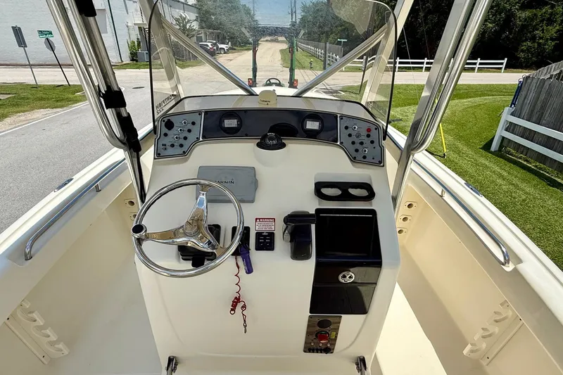 Slide: The Image of 2008 Scout 222 Sportfish boat dashboard with steering wheel and controls. - 10
