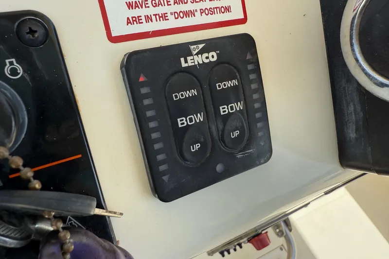 Slide: The Image of Control panel of a 2008 Scout 222 Sportfish boat with Lenco trim tab switches. - 18