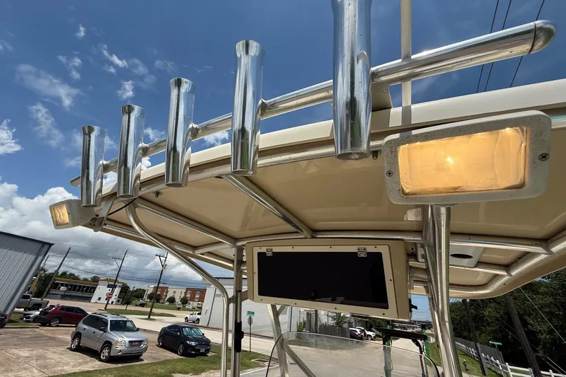 Slide: The Image of 2008 Scout 222 Sportfish boat with rod holders and lights under a clear blue sky. - 19