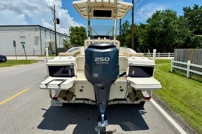 Slide: The Image of 2008 Scout 222 Sportfish boat with 250 horsepower engine on a sunny street. - 3