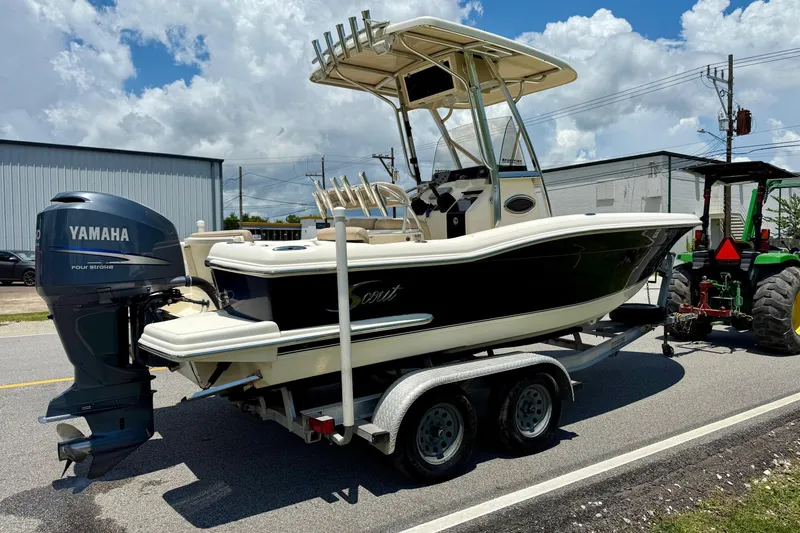 Slide: The Image of 2008 Scout 222 Sportfish boat on trailer with Yamaha outboard motor, parked outdoors. - 4