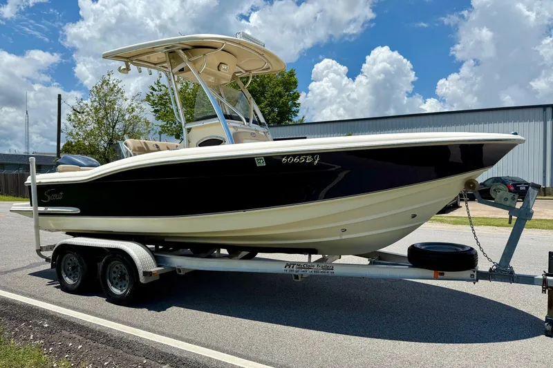 Slide: The Image of 2008 Scout 222 Sportfish boat on trailer under a cloudy sky. - 5