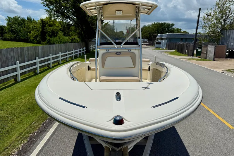 Slide: The Image of 2008 Scout 222 Sportfish boat on trailer, parked on a suburban street. - 6