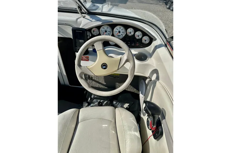 Slide: The Image of 2010 Stingray 205 CS/CX boat cockpit with steering wheel and dashboard controls. - 10
