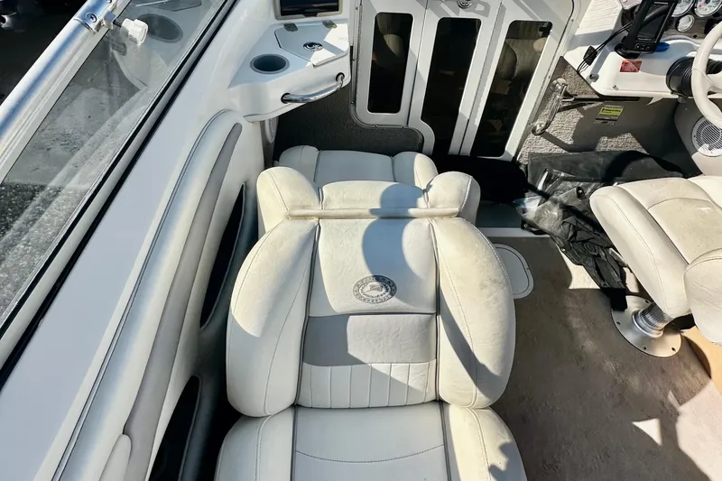 Slide: The Image of Interior of a 2010 Stingray 205 CS/CX boat with white leather seating. - 12