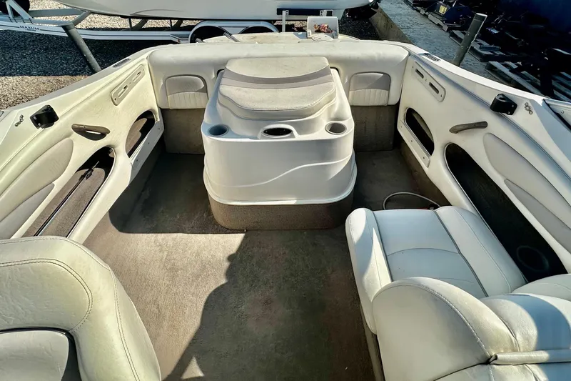 Slide: The Image of Interior of a 2010 Stingray 205 CS/CX boat with white seating and central console. - 13