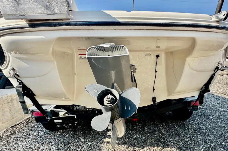 Slide: The Image of Rear view of 2010 Stingray 205 CS/CX boat with visible propeller and trailer. - 5