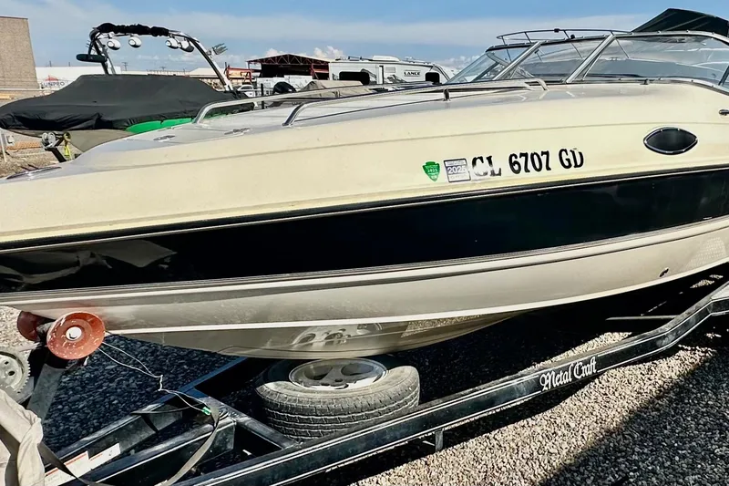 Slide: The Image of 2010 Stingray 205 CS/CX boat on trailer, parked outdoors. - 7