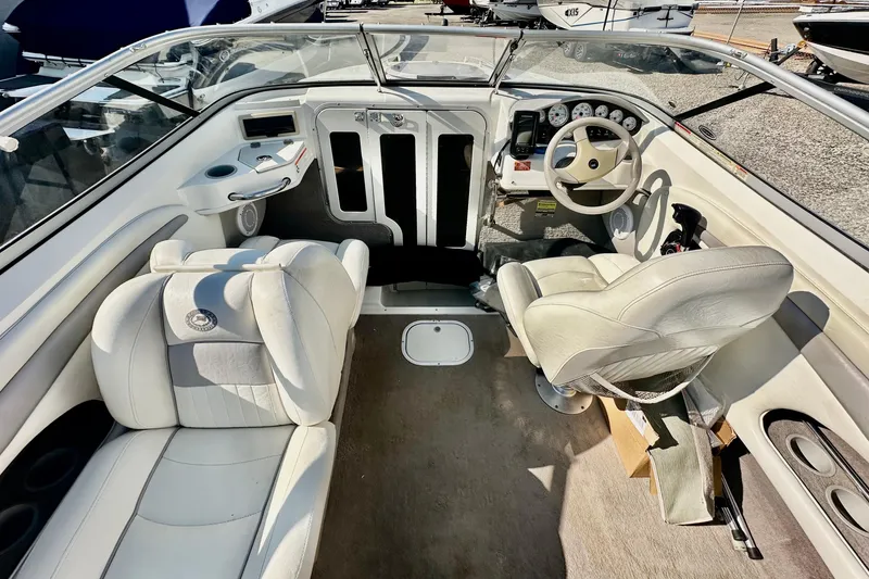 Slide: The Image of Interior of a 2010 Stingray 205 CS/CX boat with white seating and dashboard. - 8