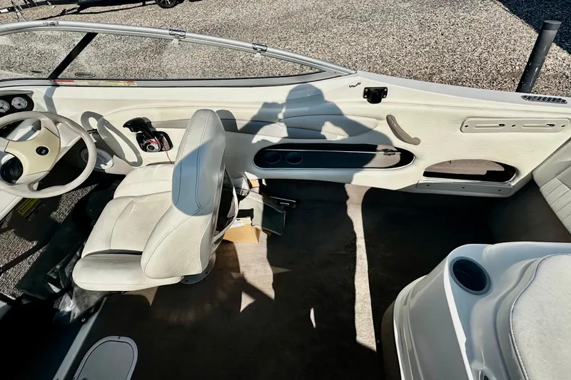 Slide: The Image of 2010 Stingray 205 CS/CX boat interior with white seating and steering wheel. - 9
