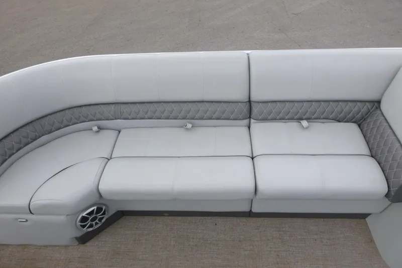 Slide: The Image of 2024 Ranger Reata 243C boat interior with plush, quilted seating and integrated speaker. - 10