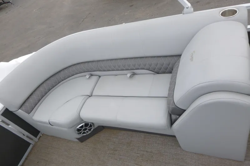 Slide: The Image of 2024 Ranger Reata 243C boat interior with plush seating and integrated speaker. - 11
