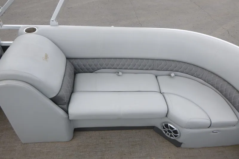 Slide: The Image of 2024 Ranger Reata 243C boat interior with luxurious gray seating and speaker. - 12