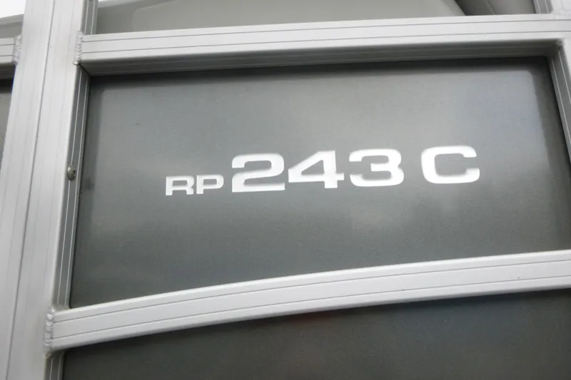 Slide: The Image of 2024 Ranger Reata 243C model emblem on metallic surface. - 13