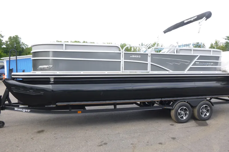 Slide: The Image of 2024 Ranger Reata 243C pontoon boat on trailer, side view. - 3