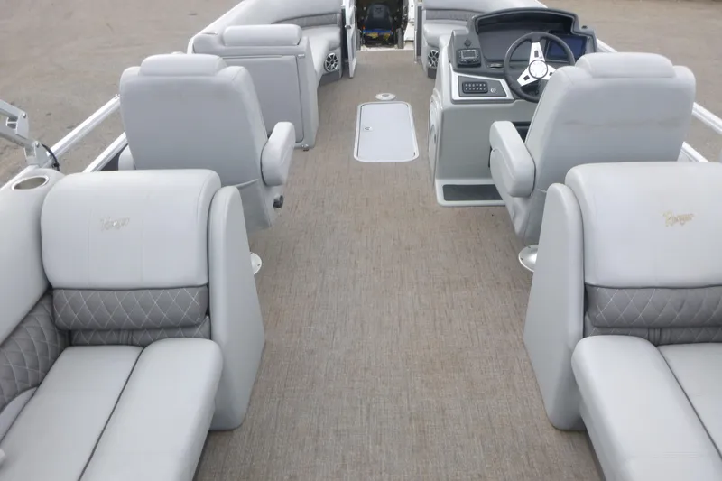 Slide: The Image of 2024 Ranger Reata 243C boat interior with plush seating and modern dashboard. - 5
