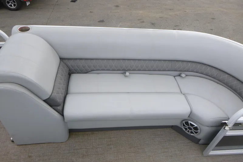 Slide: The Image of 2024 Ranger Reata 243C boat interior with luxurious gray seating and speaker system. - 9