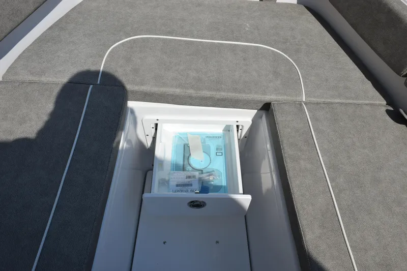 Slide: The Image of 2026 Sea Hunt Ultra 275 SE boat storage compartment with Lewmar accessory. - 19