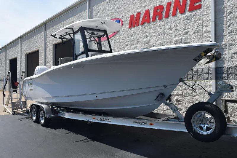 Slide: The Image of 2026 Sea Hunt Ultra 275 SE boat on trailer outside marine dealership. - 2