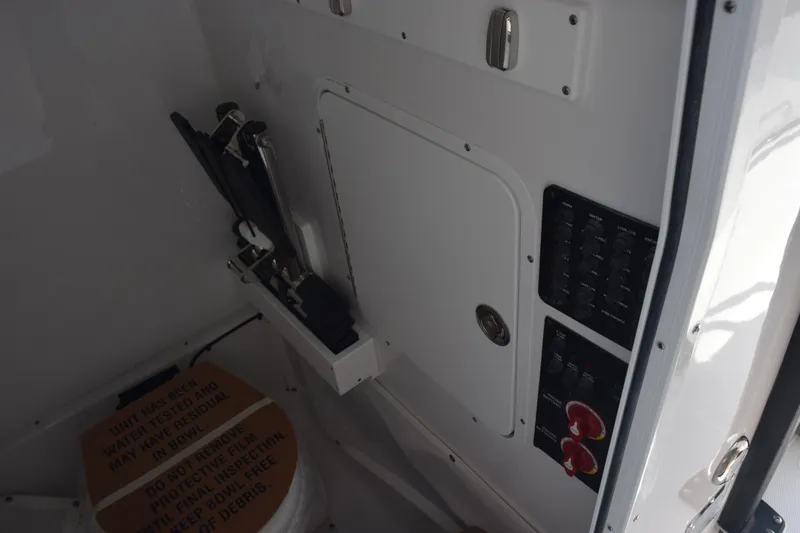 Slide: The Image of Interior view of 2026 Sea Hunt Ultra 275 SE boat, featuring control panel and storage compartment. - 23