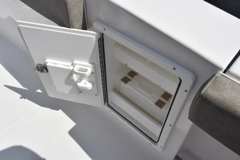 Slide: The Image of 2026 Sea Hunt Ultra 275 SE boat storage compartment with open door. - 28