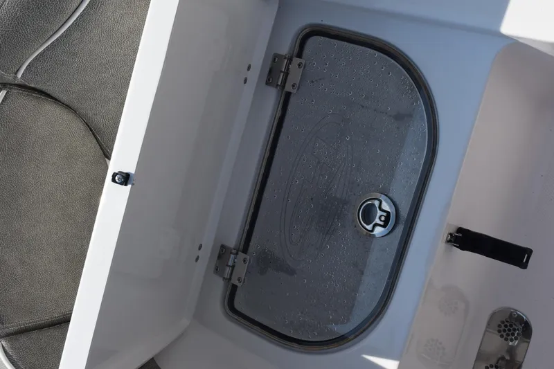 Slide: The Image of 2026 Sea Hunt Ultra 275 SE boat compartment with wet deck and secure latch. - 32