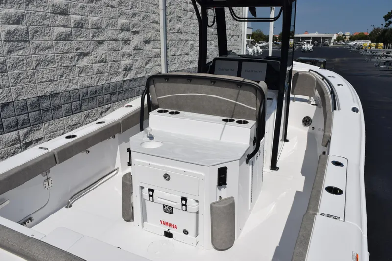 Slide: The Image of 2026 Sea Hunt Ultra 275 SE boat interior with seating and console, docked outdoors. - 7